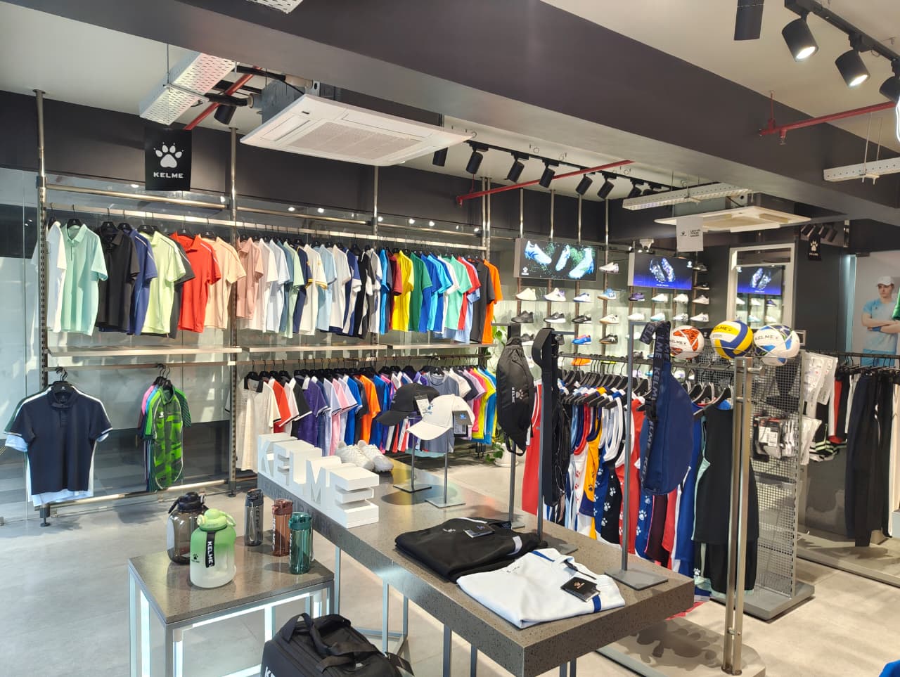 Kelme shirts, footballs and accessories displayed in the store